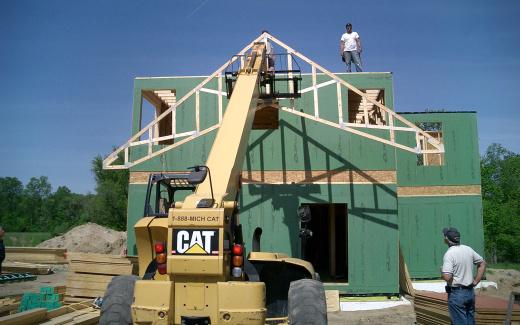 Raising first truss; Thomas on deck