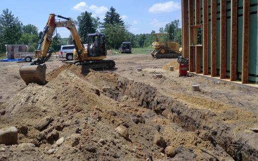 Excavating water line trench