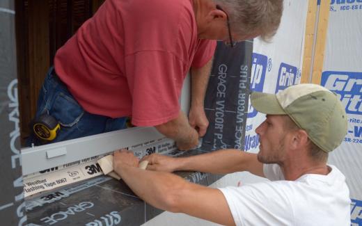 Michael and Matt sealing window frame