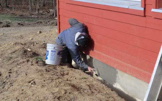 Applying concrete to exterior foundation