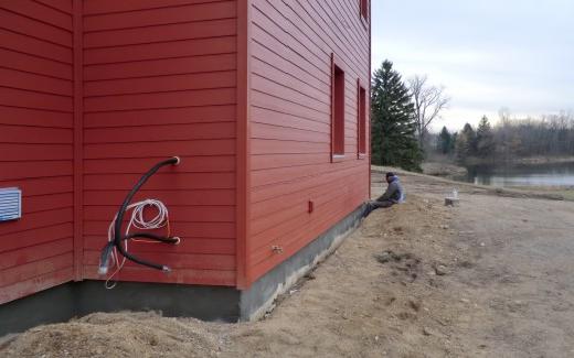 Foundation concrete; mini-split compressor lines visible