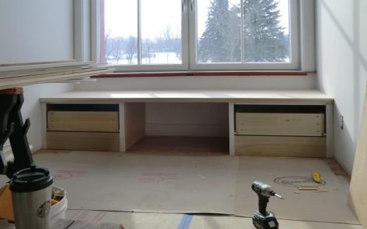 Window seat in kitchen with dog bed area in middle