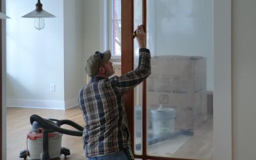 Dave cleaning trim on pocket doors between kitchen and parlor