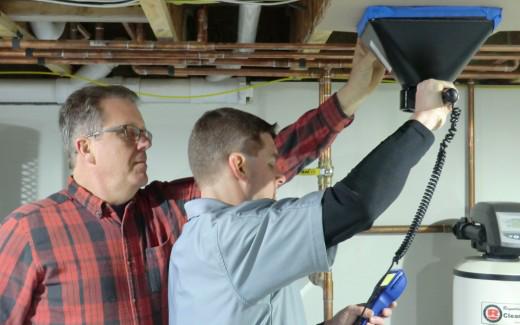 Michael and Kevin adjusting duct in crawlspace