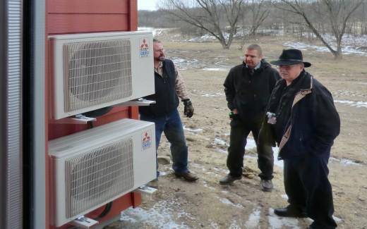 Mitsubishi representatives examining outdoor units